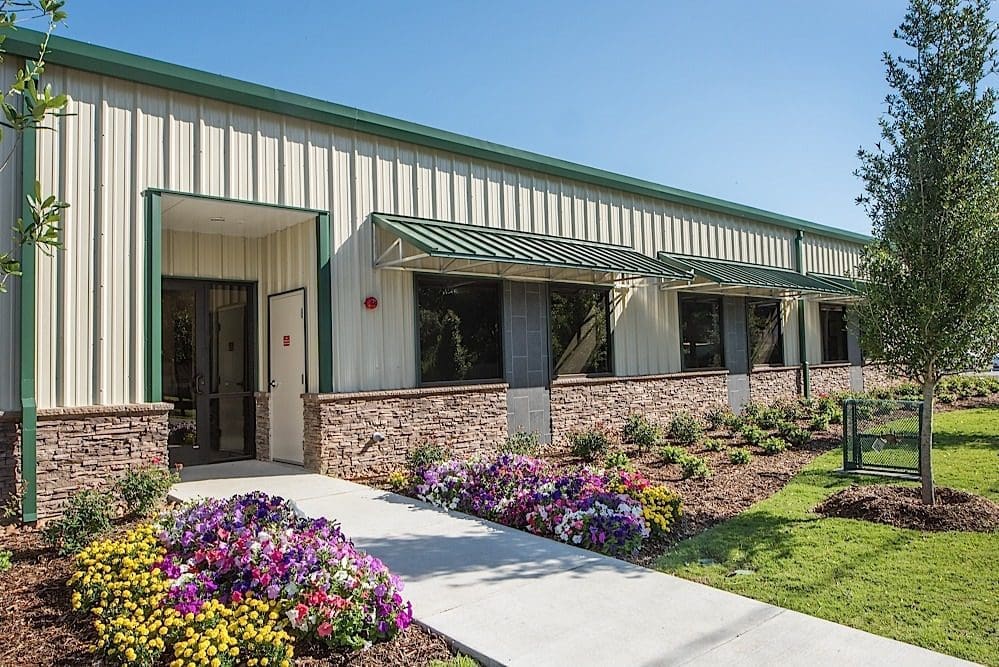 Modern building with landscaped garden entrance.