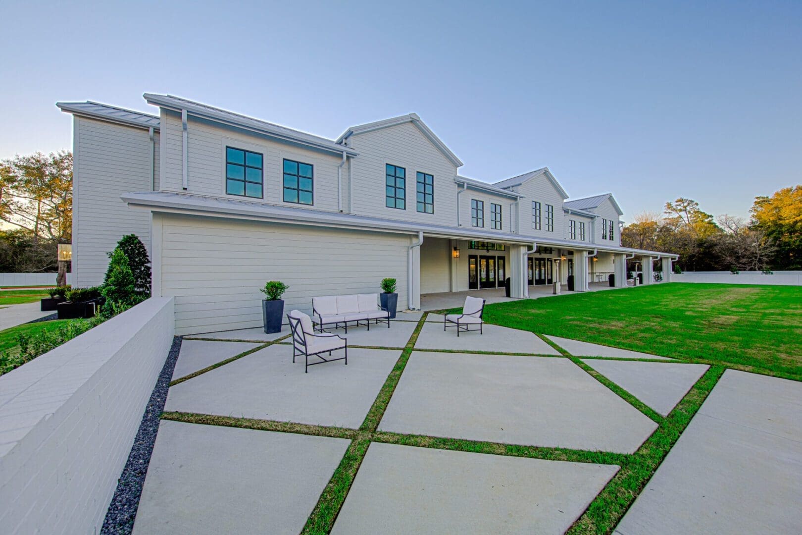 Modern white building with spacious patio area.