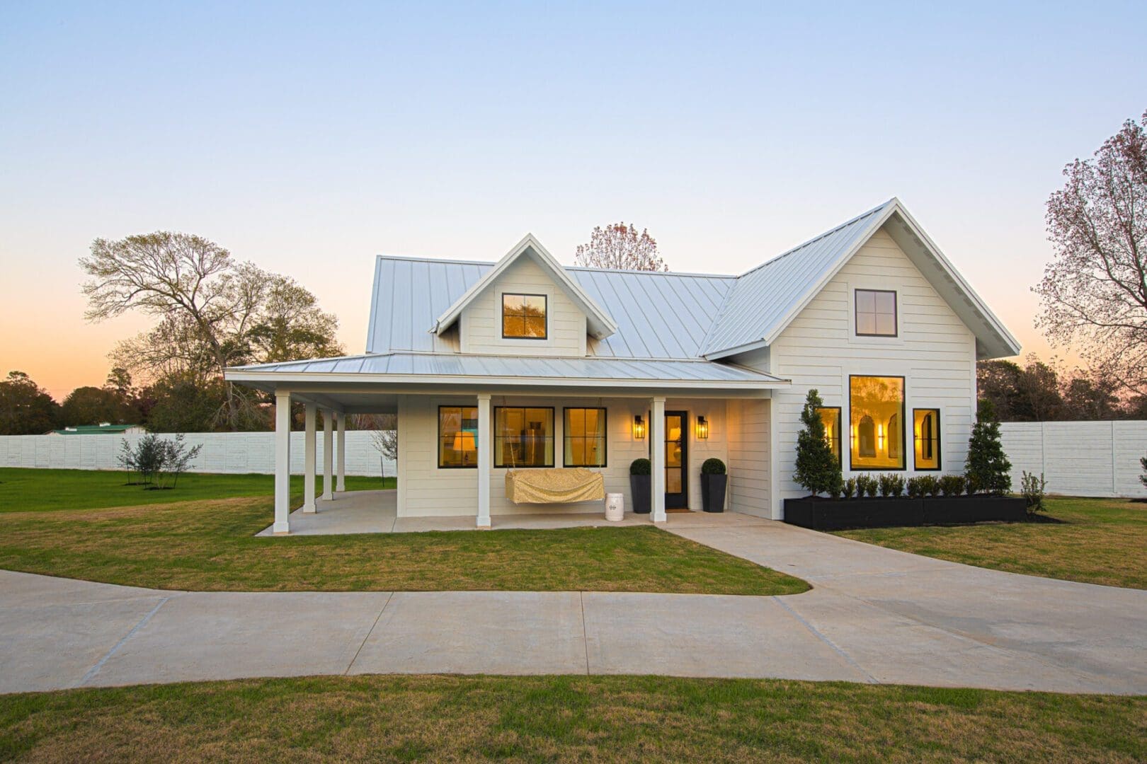 White house with a metal roof, sunset.