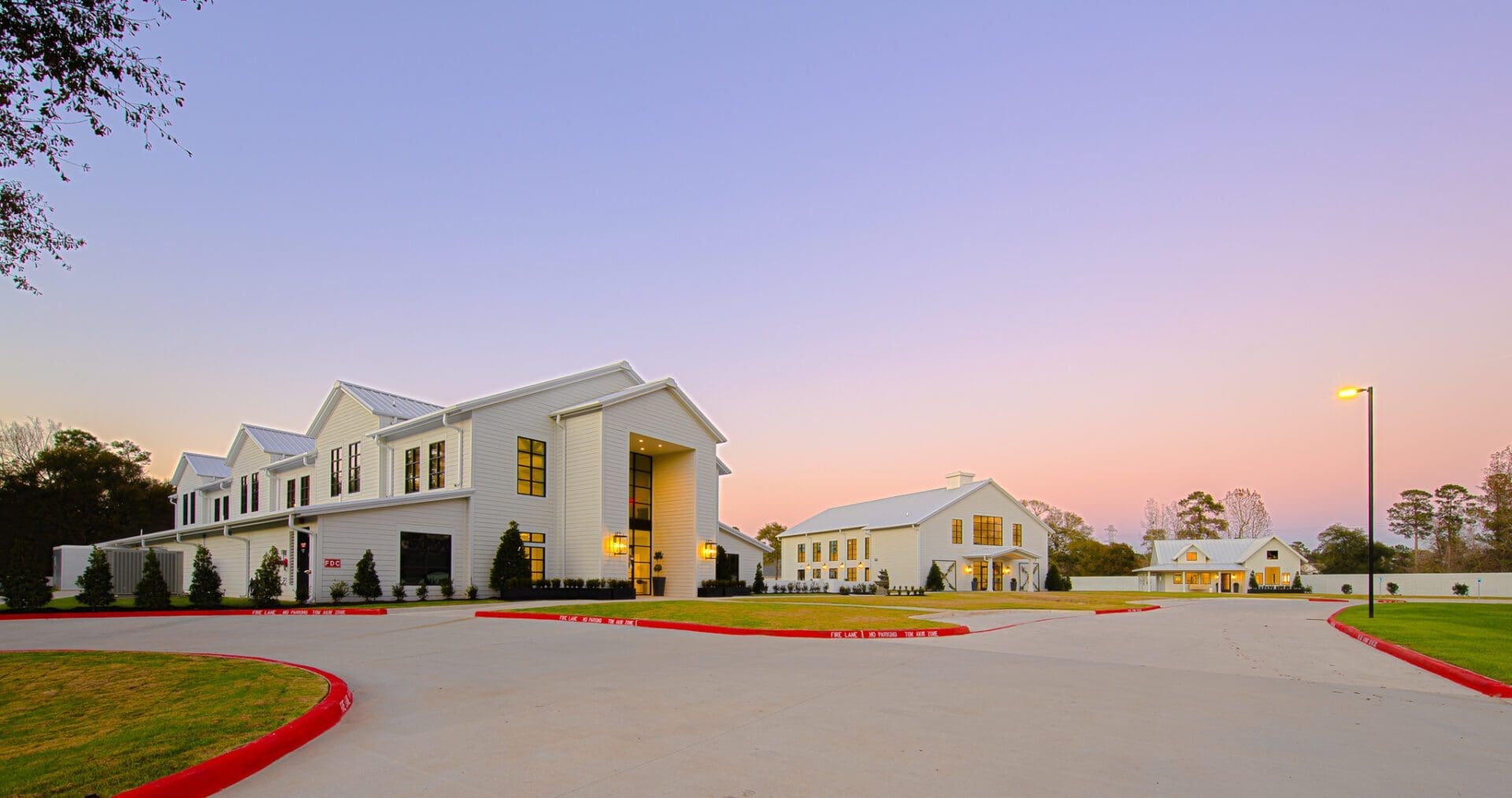 Modern buildings with a sunset sky backdrop.