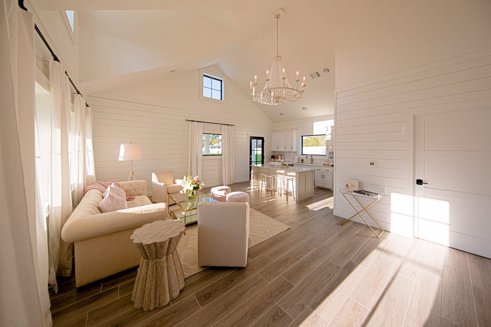 Bright, modern living room with kitchen area.