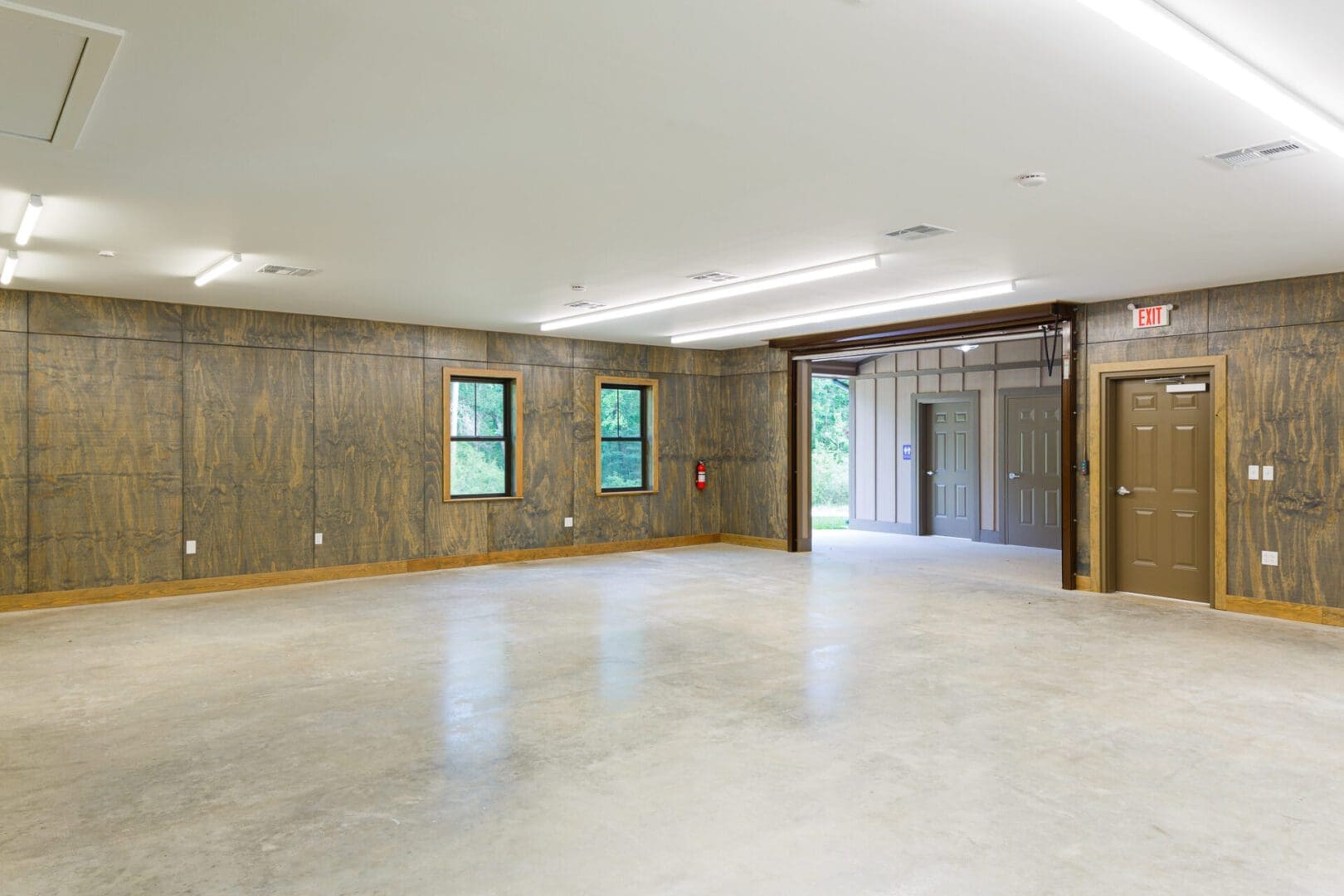 Empty room with wooden walls and doors.