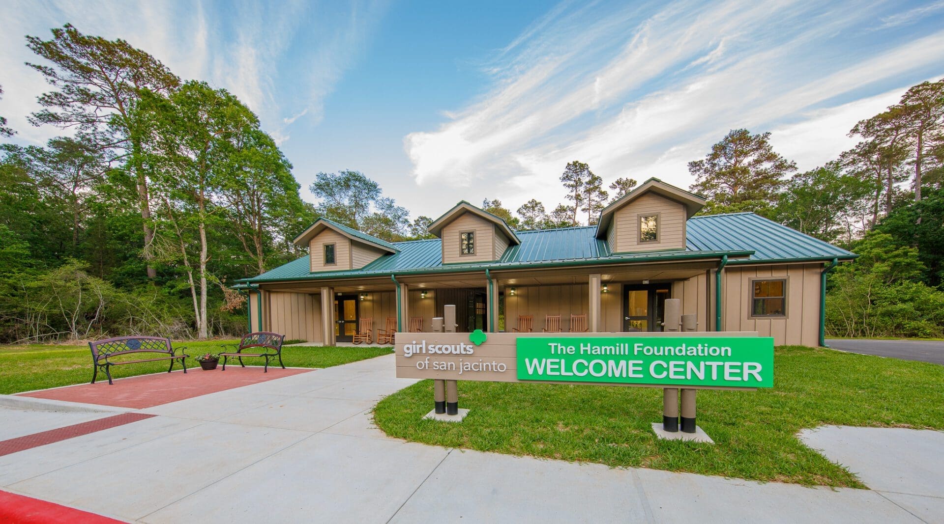 Welcome Center building with green sign outdoors.