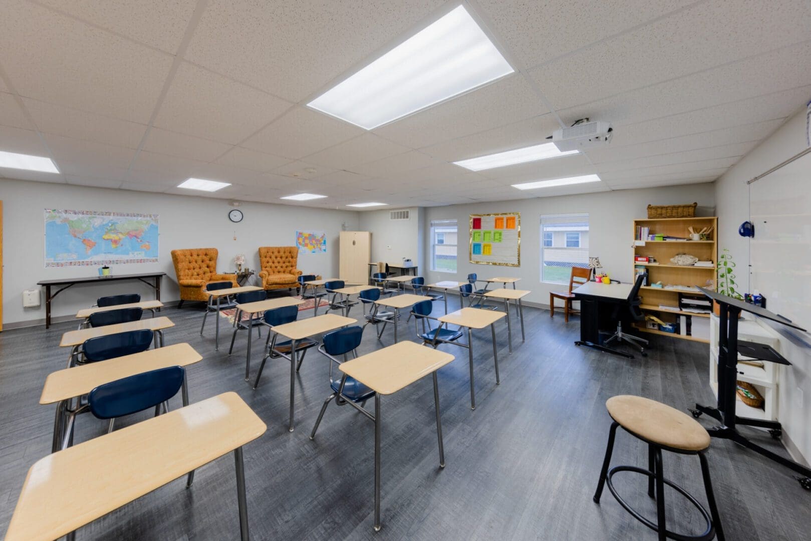 Empty classroom with desks and chairs.