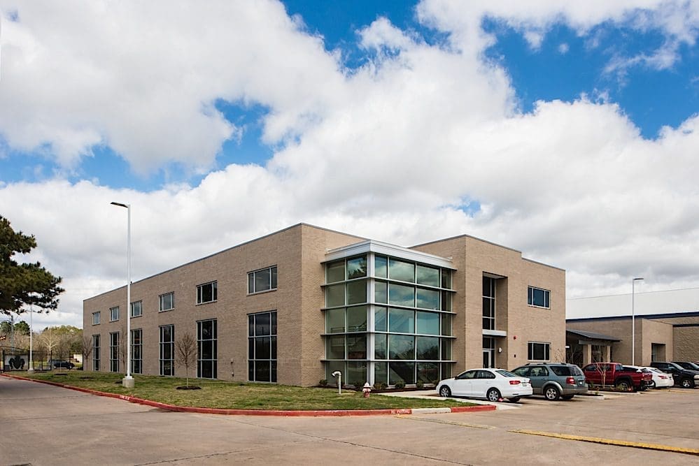 Modern office building with parked cars.