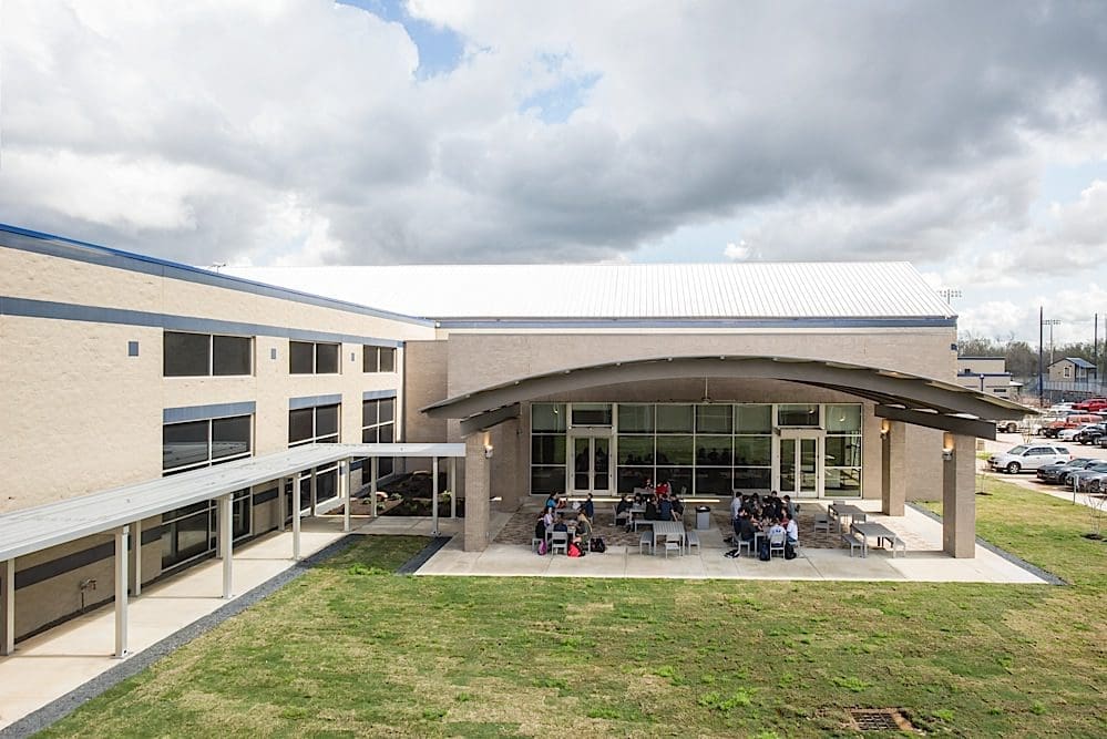 School building with outdoor seating area.