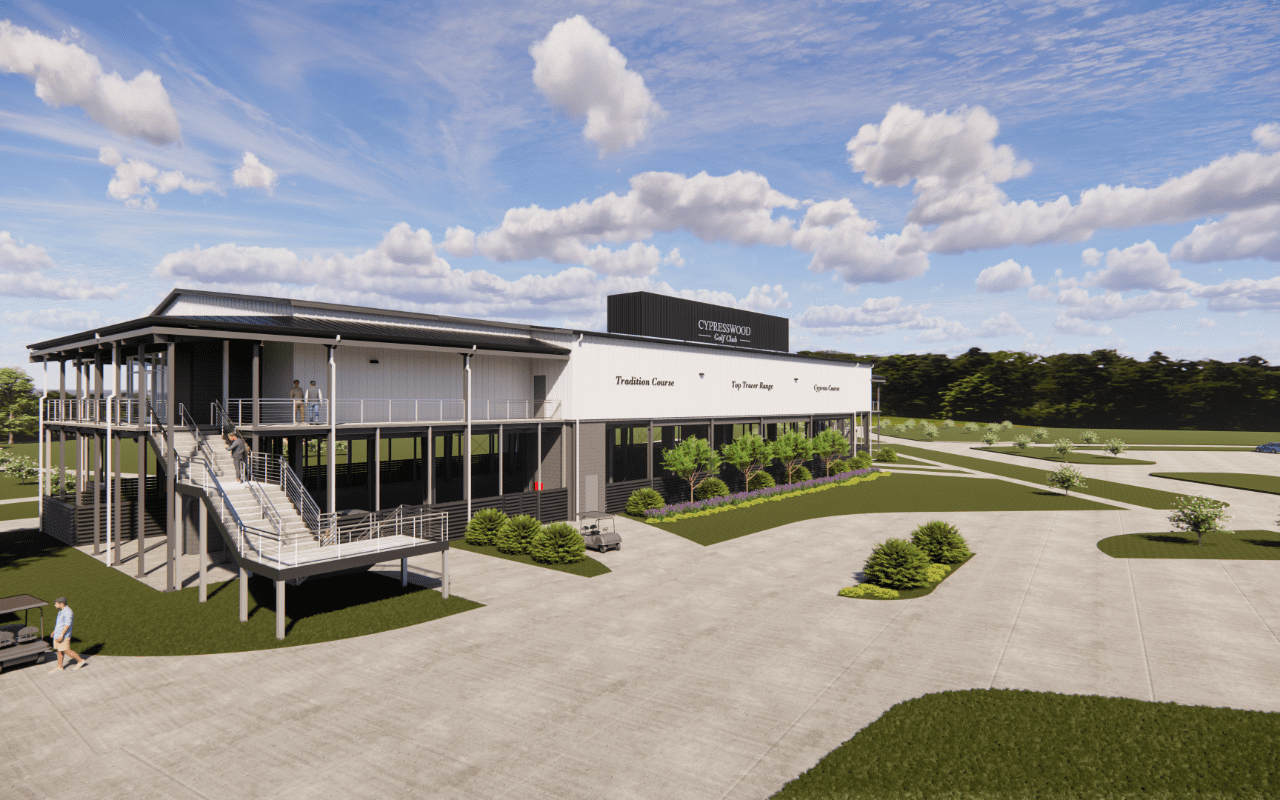 Modern building with parking and greenery.