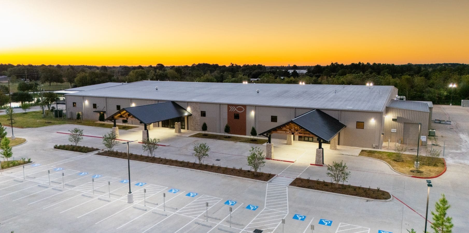 Building with parking lot at sunset.