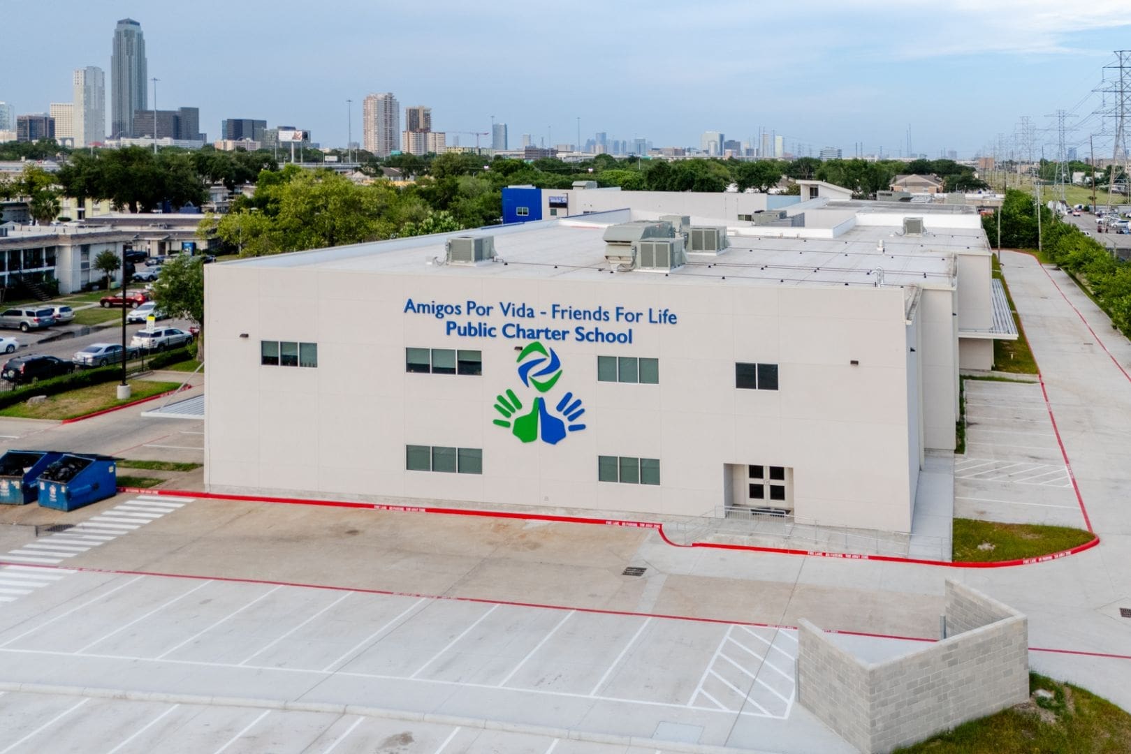 Public charter school building with city skyline.