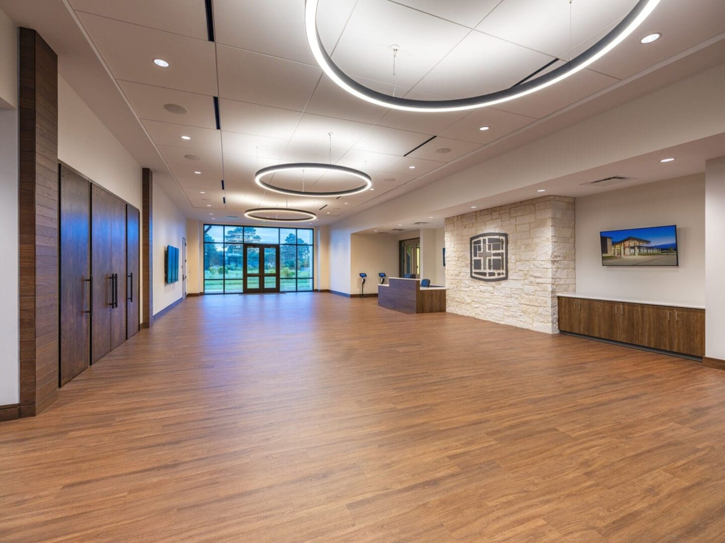 Spacious modern lobby with wooden flooring.