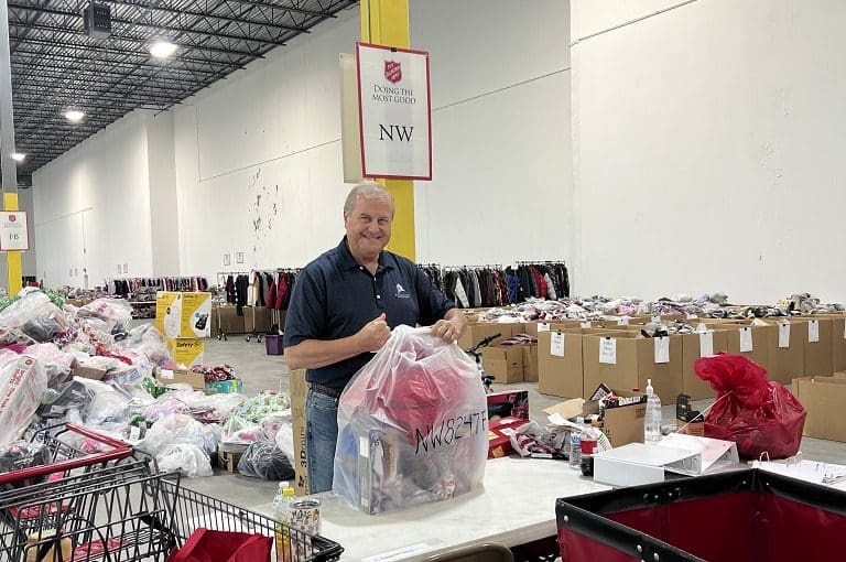 Man packing items at donation center.