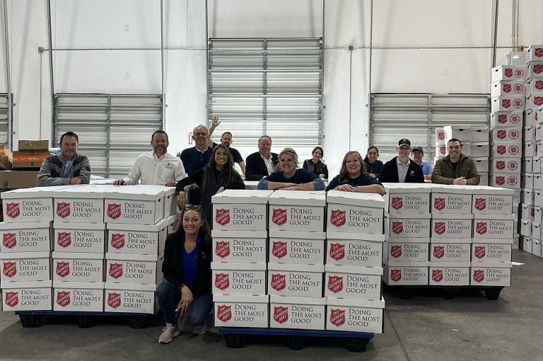 Group with Salvation Army donation boxes.