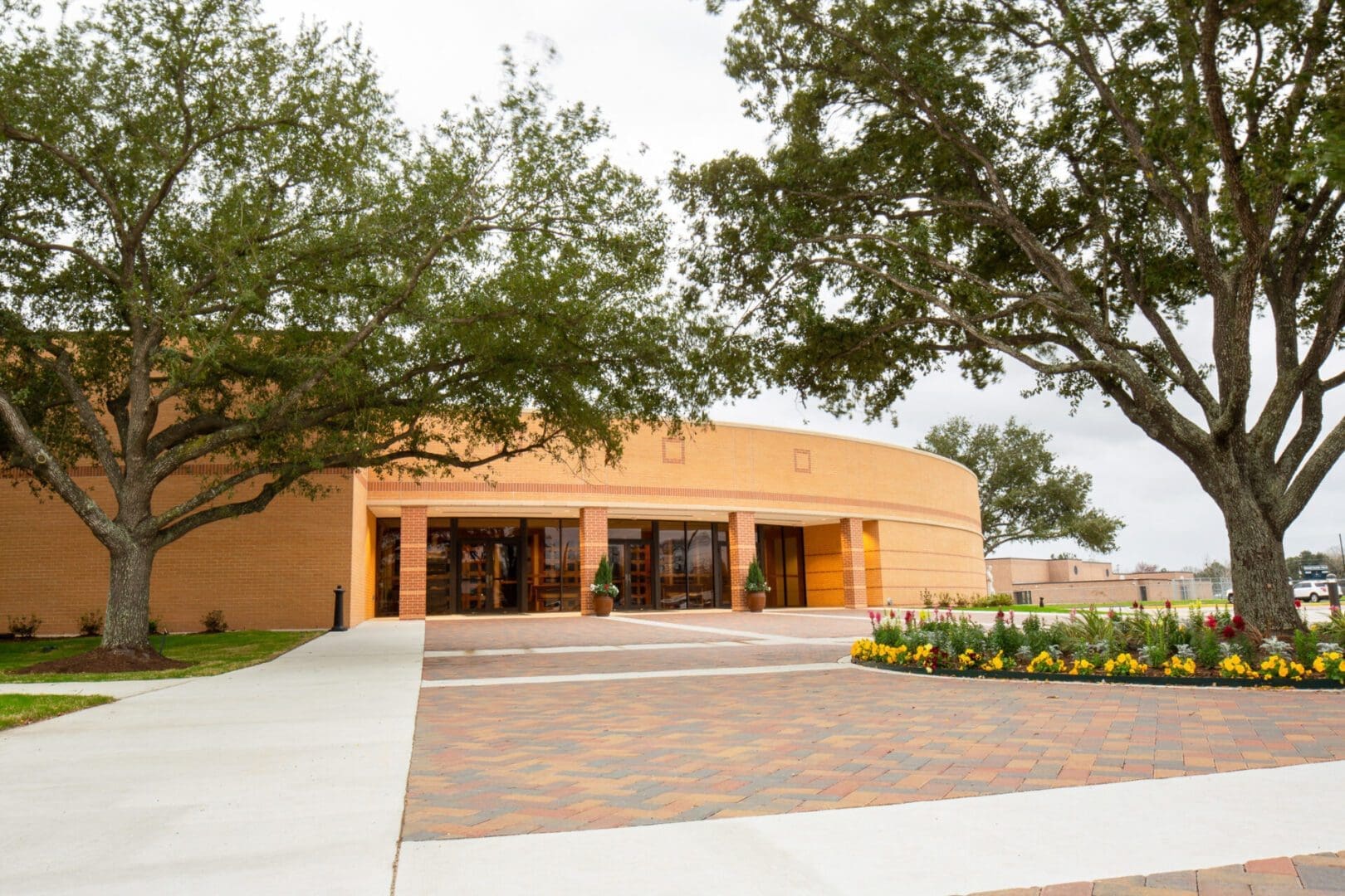 Round building with trees and pathway.