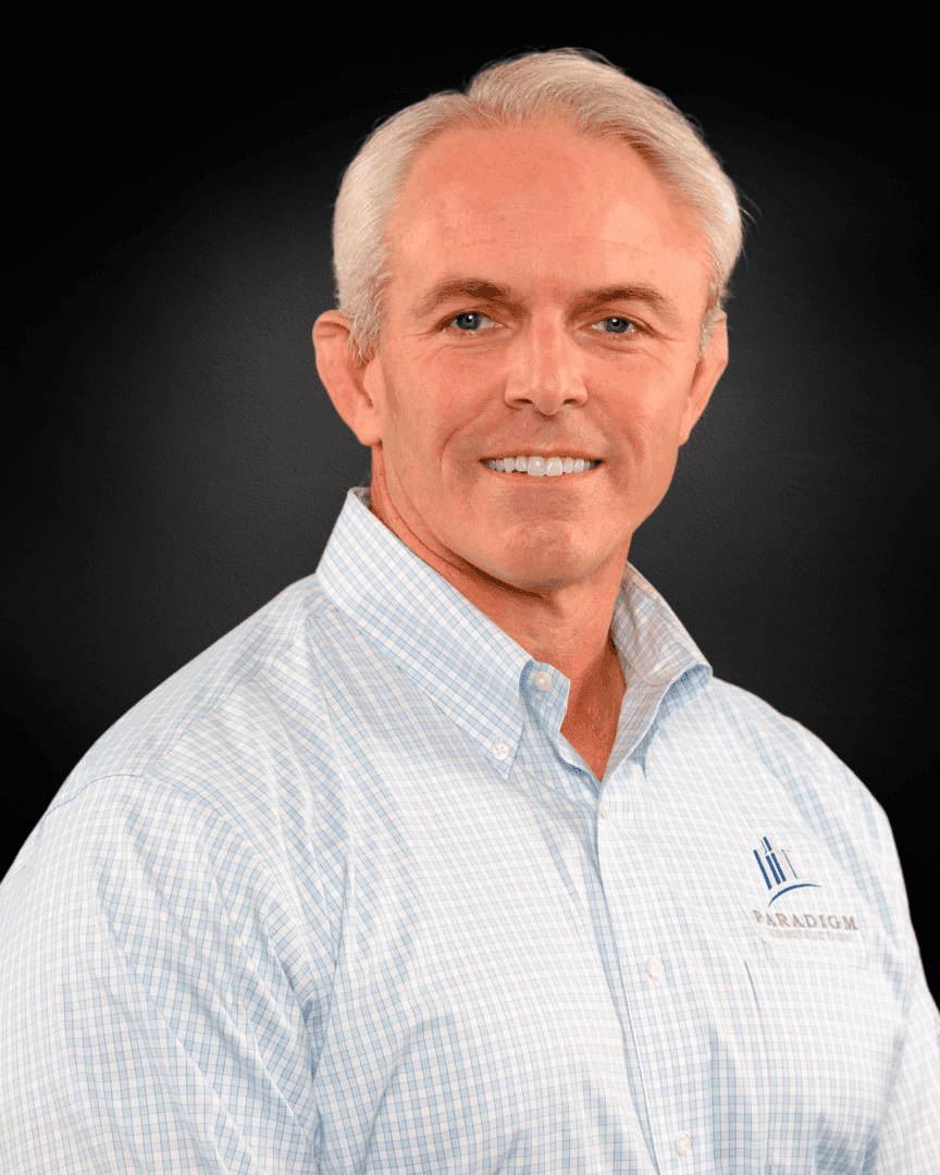 Man smiling in a checkered shirt.